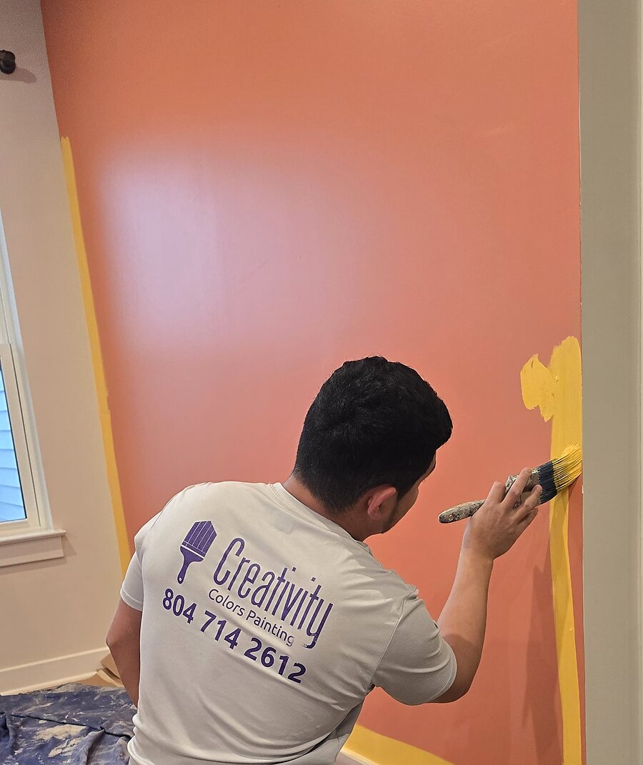 Painter applying finish coat to a ceiling