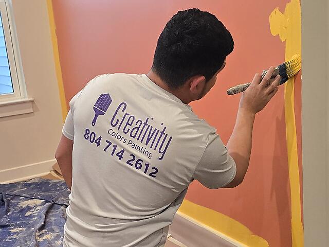 Painter applying finish coat to an interior wall